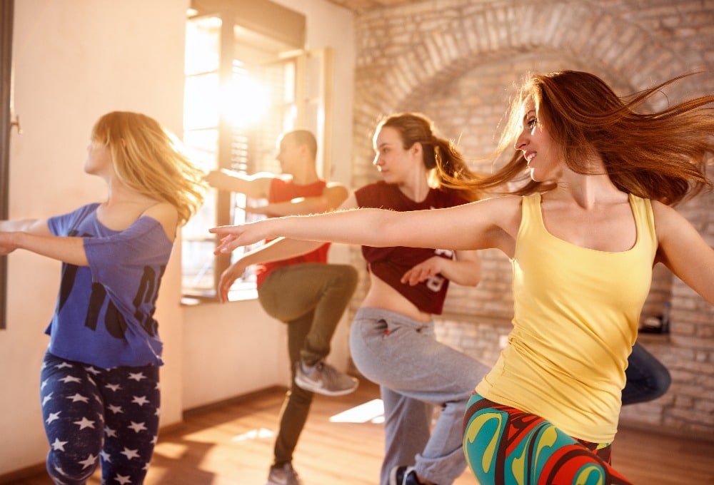 Dancers dancing in dancing studio